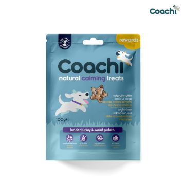 Coachi Natural Calming Treats for dogs in a light blue resealable pouch, featuring illustrations of a white dog and a treat, on a white background.