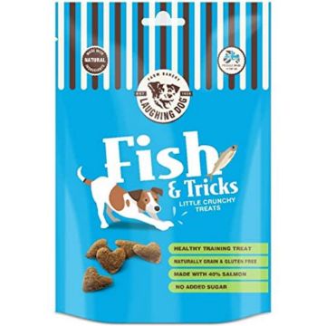A blue bag of Laughing Dog Fish & Tricks dog treats, featuring a cartoon dog and salmon fillet illustration on the front, with several salmon treats visible at the bottom left.