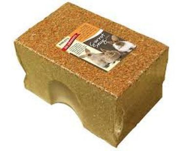 A natural cork rabbit hut with a cutout entrance, featuring a printed product label on top, set against a plain white background.