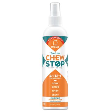 A bottle of Tropiclean Chew Stop Behavior 4-in-1 spray, featuring a white bottle with a clear spray top, an orange and teal label, and a white cap, set against a plain white background.