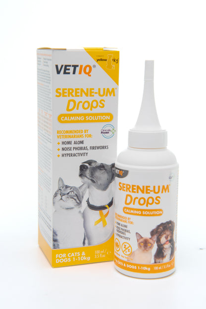 A bottle of VETIQ Serene-UM Calming Solution Drops for cats and dogs with its packaging box, displaying the product name, usage instructions, and images of cats and a dog.