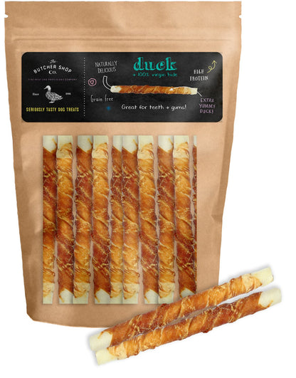 A pack of The Butcher Shop Co. dog treats, featuring white twisted sticks wrapped in duck, with an additional twisted stick displayed outside the pack.