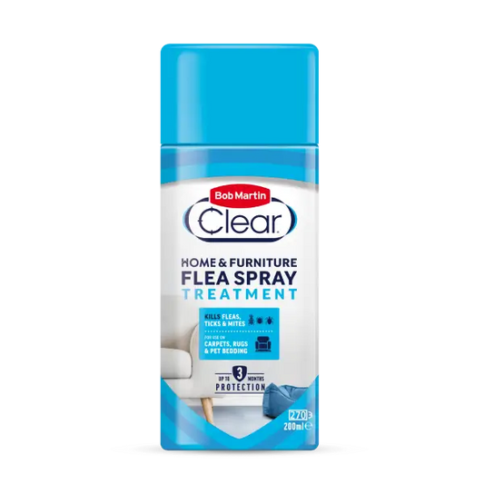 A bottle of Bob Martin Clear Home & Furniture Flea Spray Treatment, featuring a bright blue cap and a white and blue label with product details.