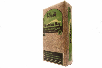 A bale of Pillow Wad Meadow Hay in a brown packaging bag with green label.