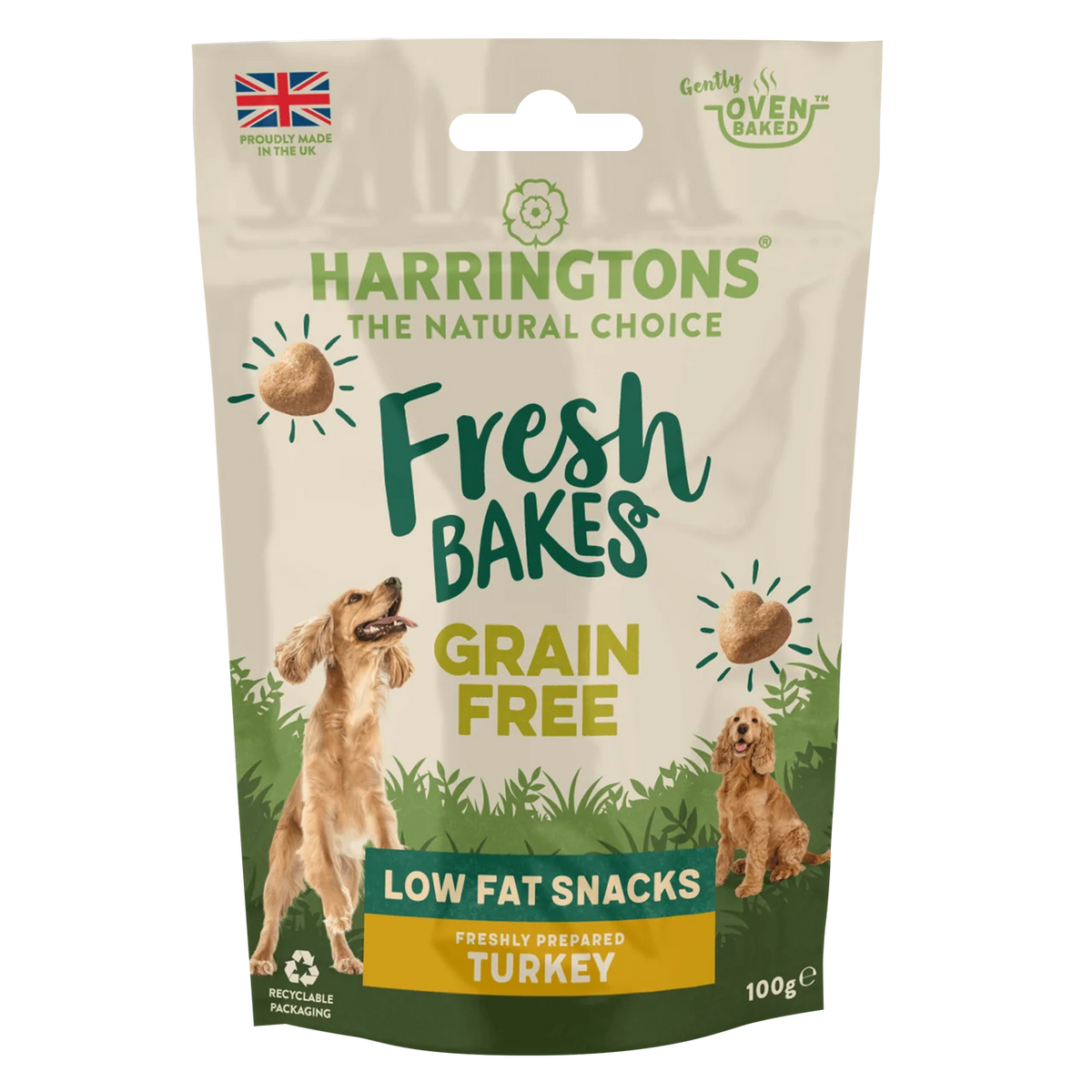 A 100g stand-up pouch of Harringtons Fresh Bakes Grain Free Low Fat Snacks, Freshly Prepared Turkey, for dogs. The packaging features a beige background with green and yellow text, illustrations of two golden retriever dogs, and a green bottom section.