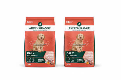 Two Arden Grange Daily All Breeds Puppy Chicken & Rice 12kg bags side by side on white background