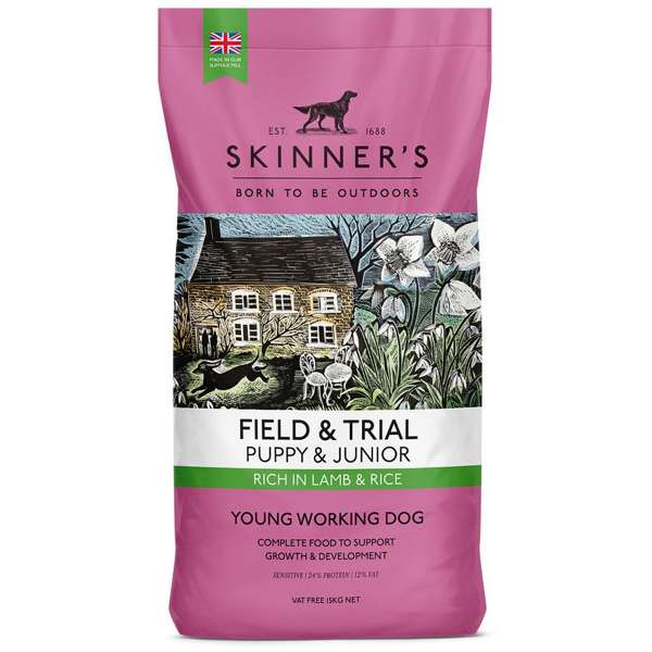A bag of Skinner's Field & Trial Puppy & Junior Lamb & Rice dog food with a picture of a dog, house and flowers on the front.